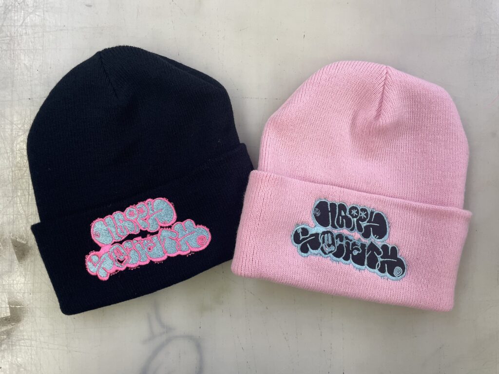 Two cuffed beanies with embroidered band logo