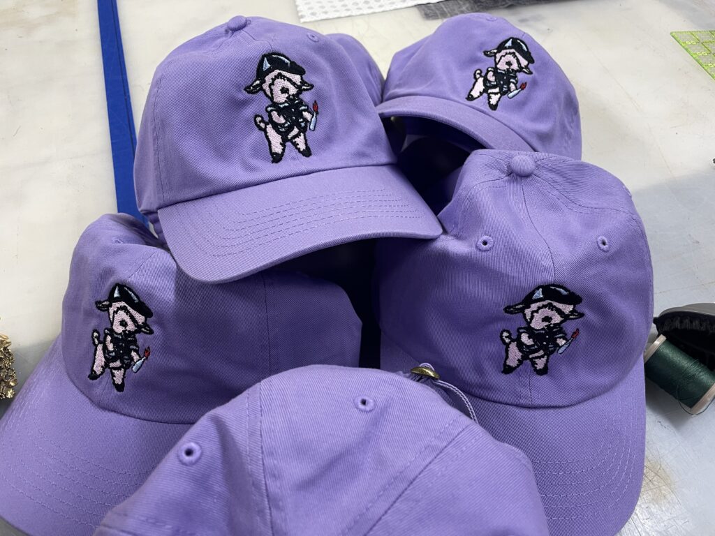 Purple custom embroidered hats for a brand in Portland, OR